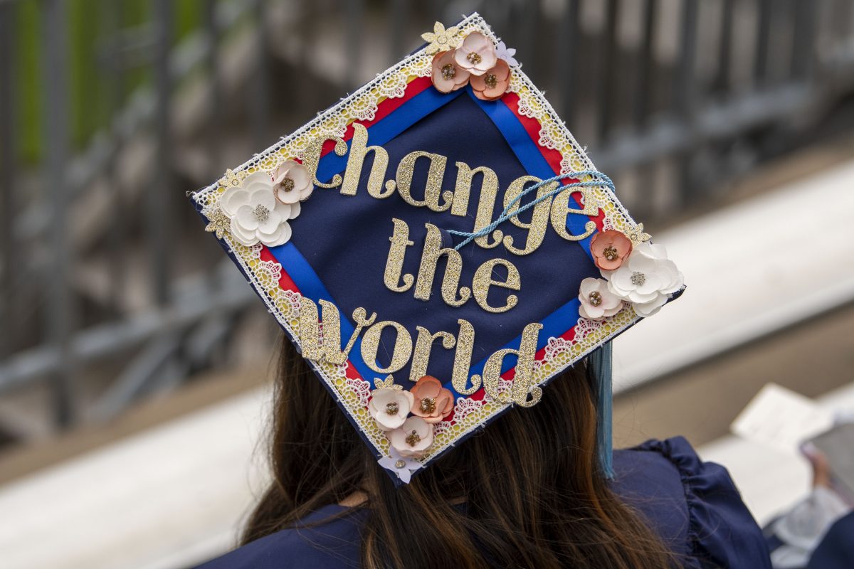 graduation mortarboard decorated with "change the world"