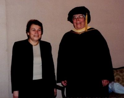 Nancy A. Humphreys in cap and gown with colleague